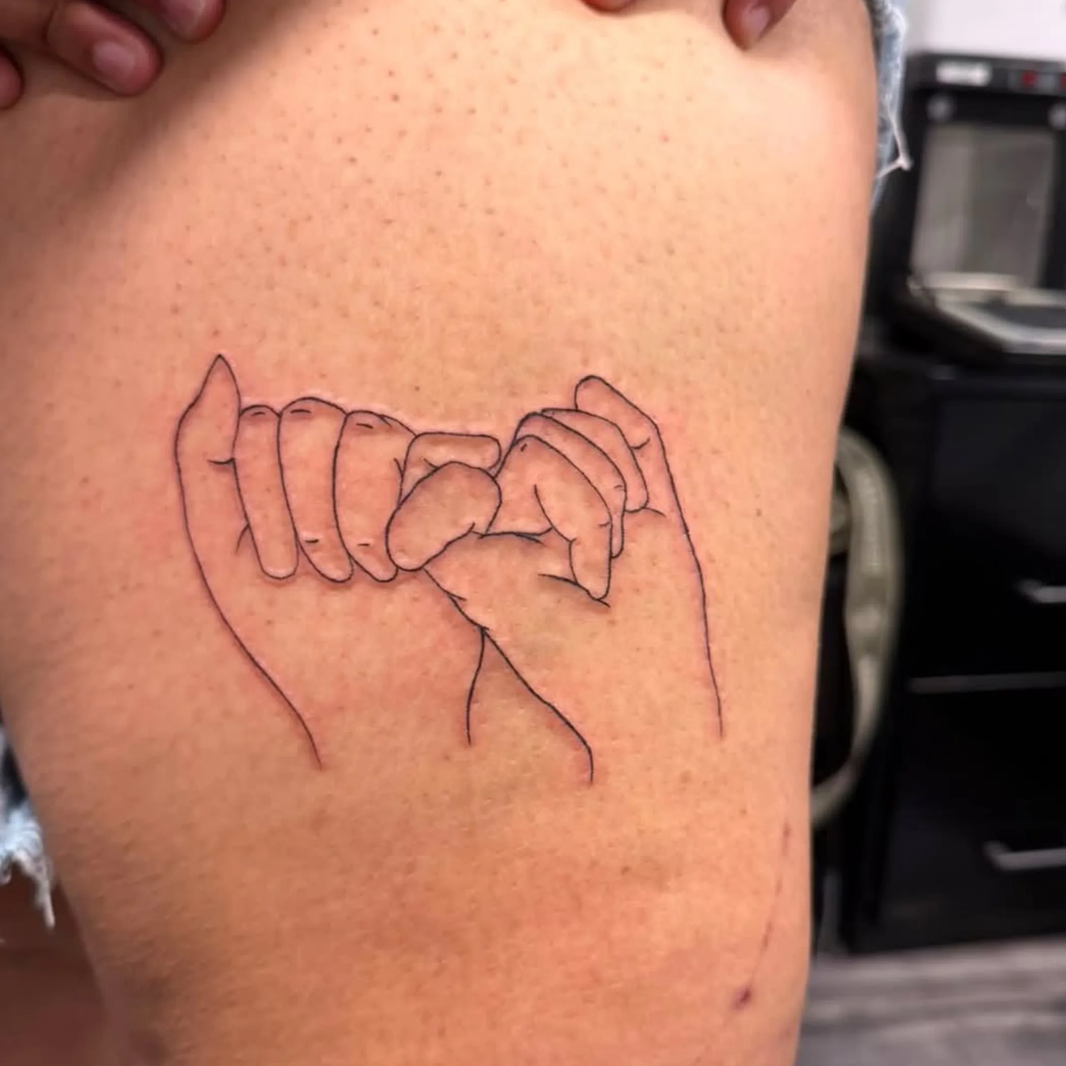 simple black line tattoo on skin