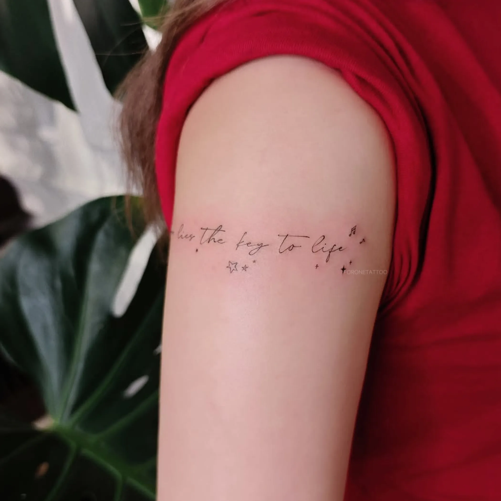 simple black line tattoo on arm